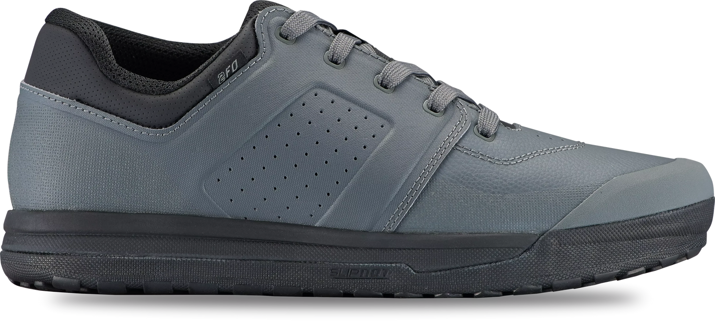 The Specialized 2FO DH Flat Mountain Bike Shoe in gray features a black sole for superior pedal grip, a perforated side panel, and a black ankle collar, shown in side profile on a white background.
