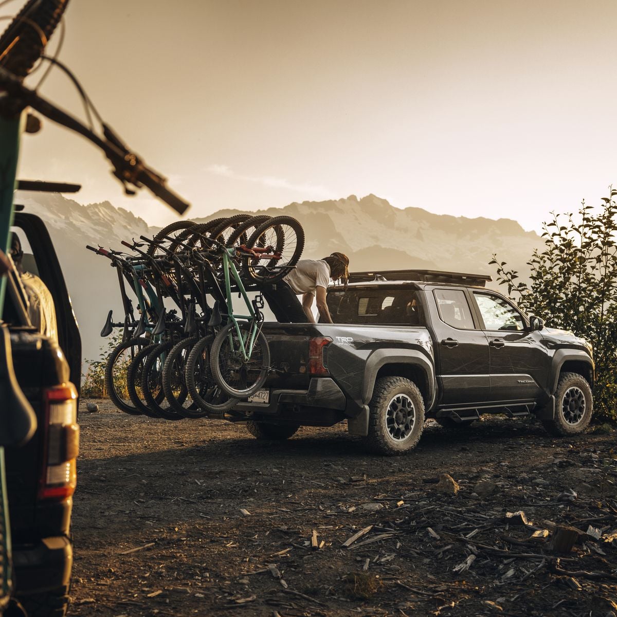 Hitch-mounted bike rack with several bicycles on a rear pickup