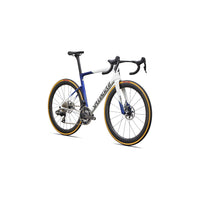 Road bike with blue-and-white frame, drop handlebars, disc brakes, gold-rim accents