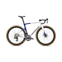 White and blue road bike with black saddle, disc brakes, and deep-section wheels