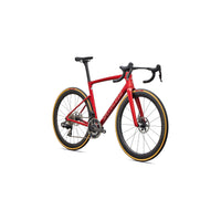 Red road bicycle with black handlebars, disc brake rotors, and gold-trim tires