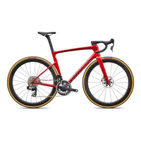 Red road bicycle with black bar tape, disc brakes, and aerodynamic frame