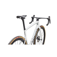 Front close-up of white road bike showing aero handlebars, fork, and disc brake