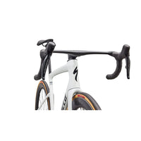 Aero road bike front close-up with black handlebar controls and white frame