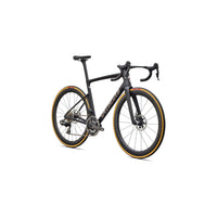 Road bike three-quarter view with black frame, drop handlebars, disc brakes, gold rim accents