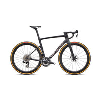 Road bike side view with matte black frame and gold rim trim, disc brakes
