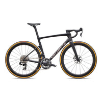 Road bike with black frame, drop handlebars, disc brakes, gold-rim accents