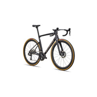 Black road bike three-quarter view with aero handlebars, disc brakes, and orange-rim tires
