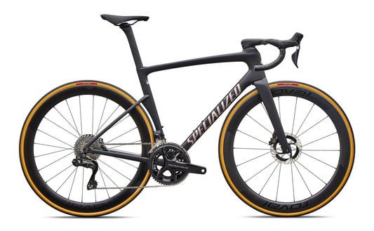 Black road bike with aero frame, drop handlebars, disc brakes, and orange-rim tires