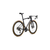Road bike, matte black frame with orange-accent wheels and drop handlebars
