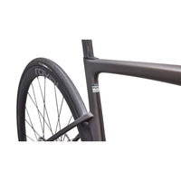 Road bike front wheel and fork with dark frame and black tire