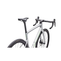 Silver road bike front section with black saddle, handlebars, and green stripe