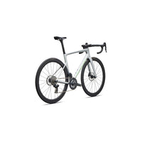 Silver road bike with black disc brakes and drivetrain, green accent stripe on frame