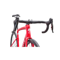 Red road bike front with drop handlebars and textured bar tape