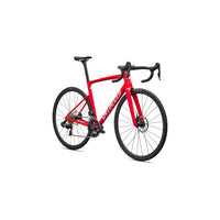 Red road bike angled view with aero fork, compact drivetrain, and disc brake