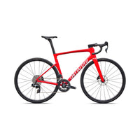 Red performance road bike side view, thin tires, disc rotors, drop bars