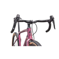 Gravel road bike close-up: pink metallic fork and handlebars with front brake cables