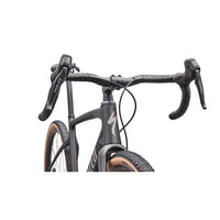 Gravel road bike detail: dark gray fork and handlebar area with front brake cables