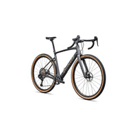 Gravel road bike angled view: dark gray frame, black cockpit, tan wheel rim trim