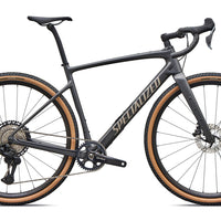 Gravel road bike side view: dark gray frame, drop bars, disc front wheel, tan trim