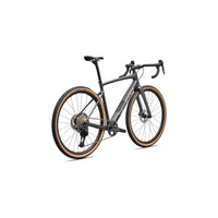 Gravel road bike side view: dark gray frame with tan tire trim, disc brakes, drop bars