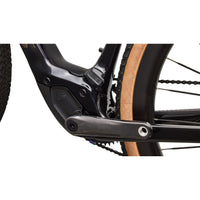 S-Works road e-bike, close-up of crank and drivetrain on black frame with orange tires