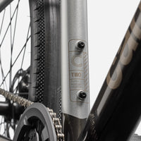 Mountain bicycle frame down tube with mounted label and silver finish