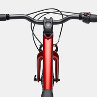 Kids red front-view bike with handlebars, brake levers, and black suspension fork
