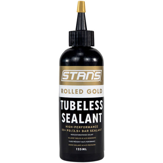 Tubeless sealant bottle with gold cap, black label