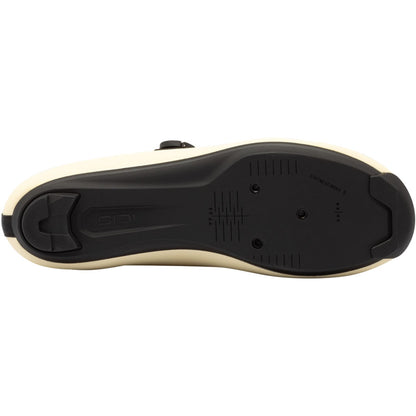Cream road cycling shoe outsole with black tread and mounting panel detail