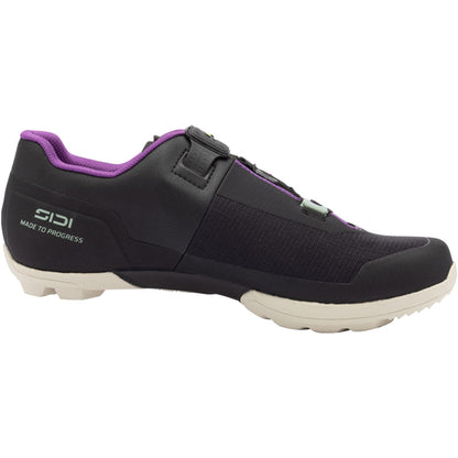 Black gravel cycling shoe with purple lining, hook-and-loop strap, and white sole