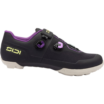 Black gravel cycling shoe with purple trim, buckle closure, and white sole tread