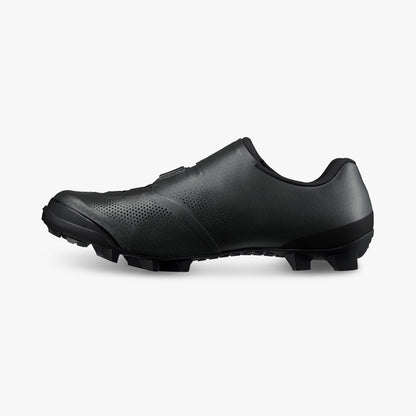 Black cycling shoes, side view with perforated toe and rugged tread sole