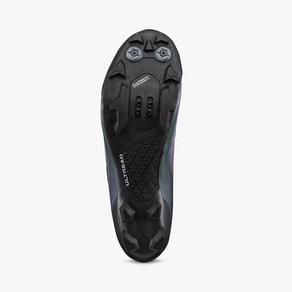 Iridescent purple cycling shoe outsole with molded traction studs and cleat mounting