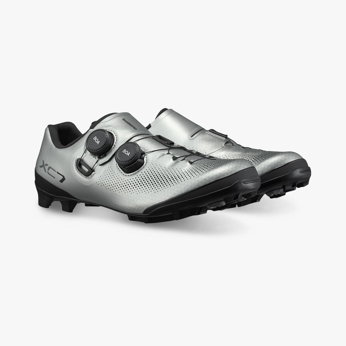 Silver cycling shoe with black cleat plate, vented upper, and two BOA dials