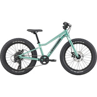 Green kids trail bike with front suspension fork and wide knobby tires