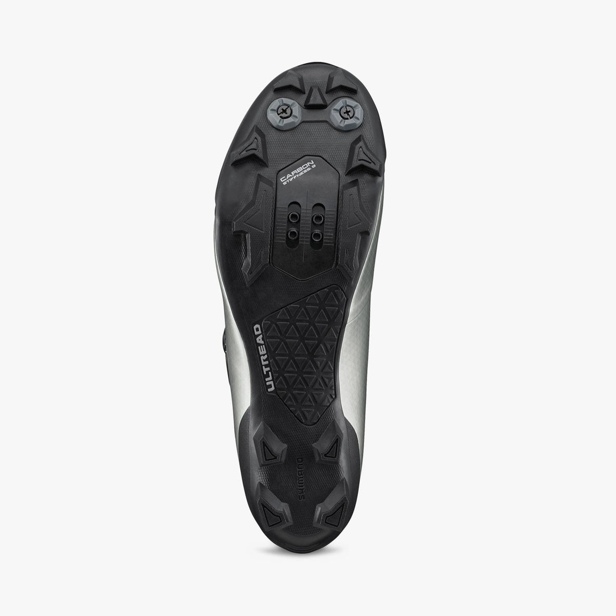 Silver cycling shoe outsole with black tread and cleat mounting pattern