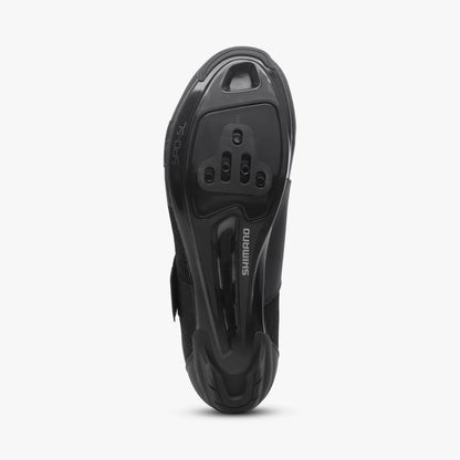 Underside of a black Shimano women's cycling shoe with cleat mounts and tread