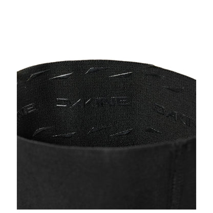 Black elbow sleeve fabric close-up with embossed/printed text and stitching