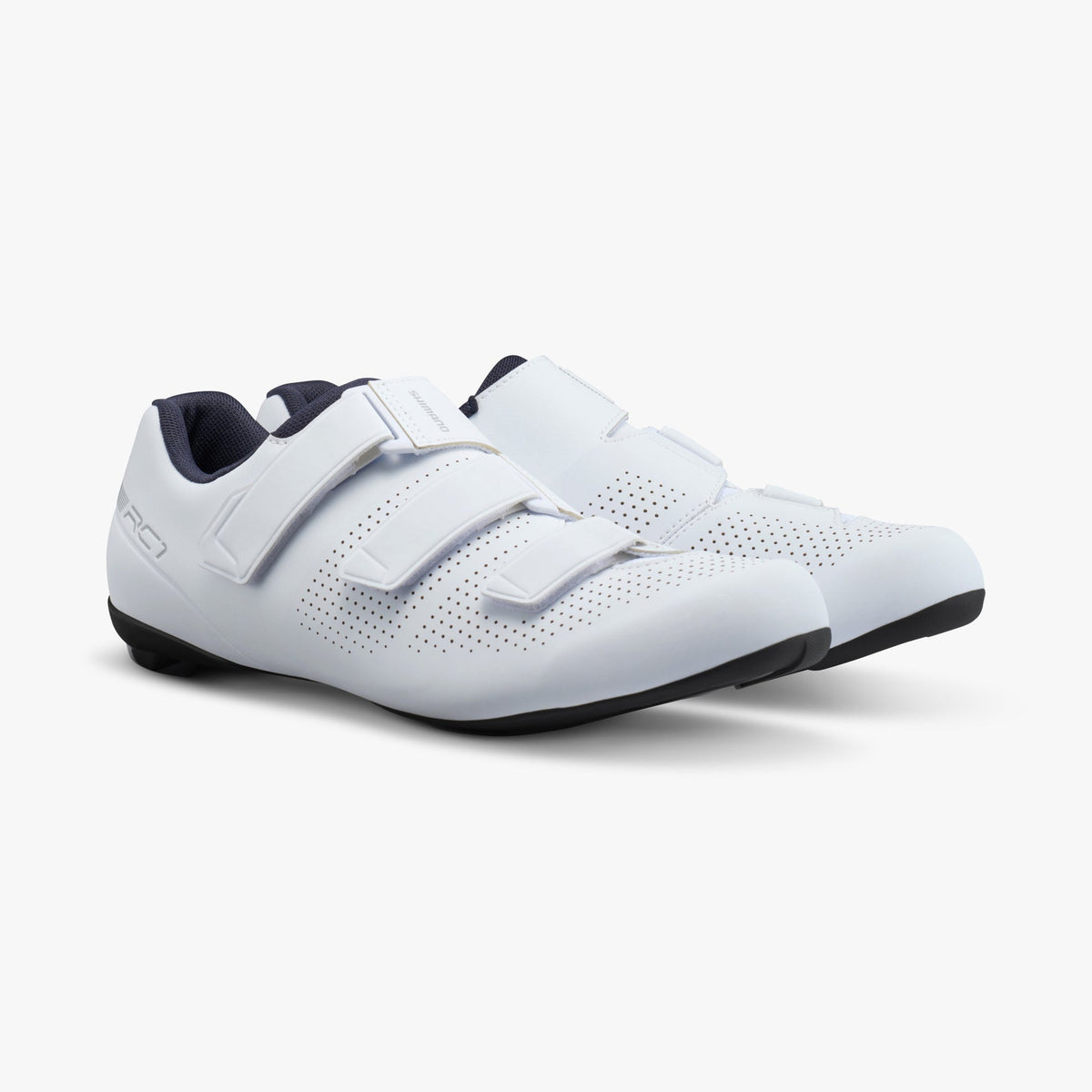 White athletic cycling shoes with three hook-and-loop straps and perforated upper