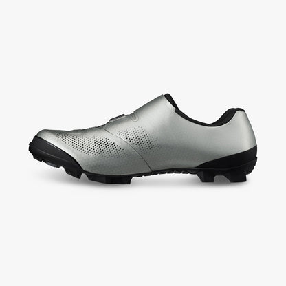 Silver cycling shoe with vented side panels, black outsole, and low-profile design