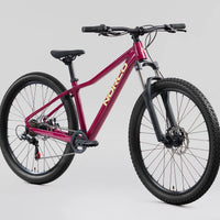 Magenta 26 in mountain bike side view, knobby tires and front disc brake rotor