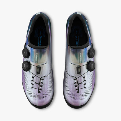 Pair of silver iridescent cycling cleat shoes with perforated toe and strap closures