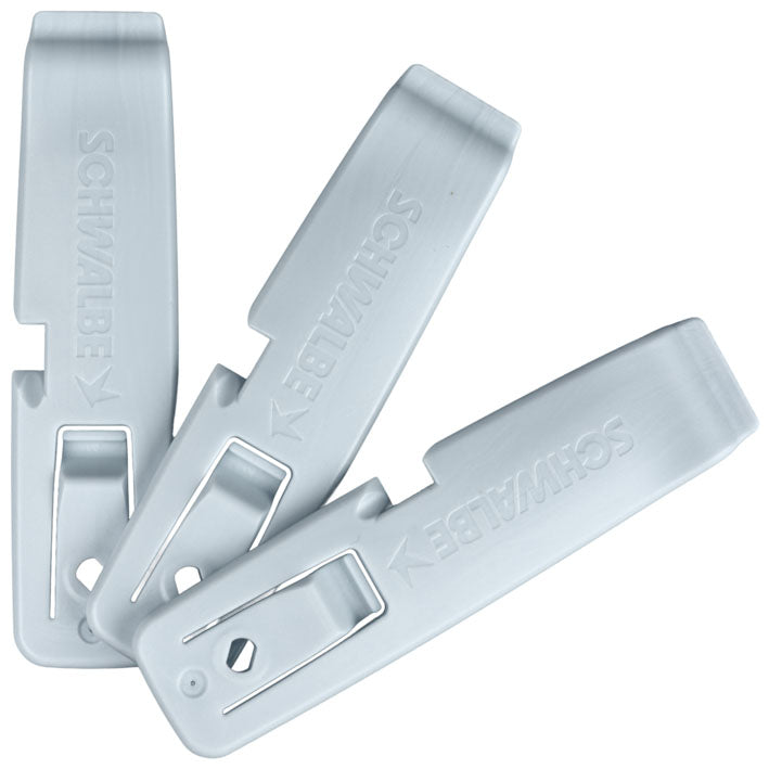 Three light-colored plastic tire levers with curved prying tips and locking hooks.