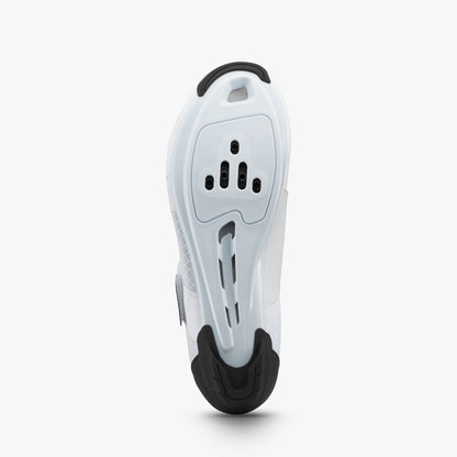 Underside of a white Shimano women's cycling shoe with cleat mounts and black heel tread