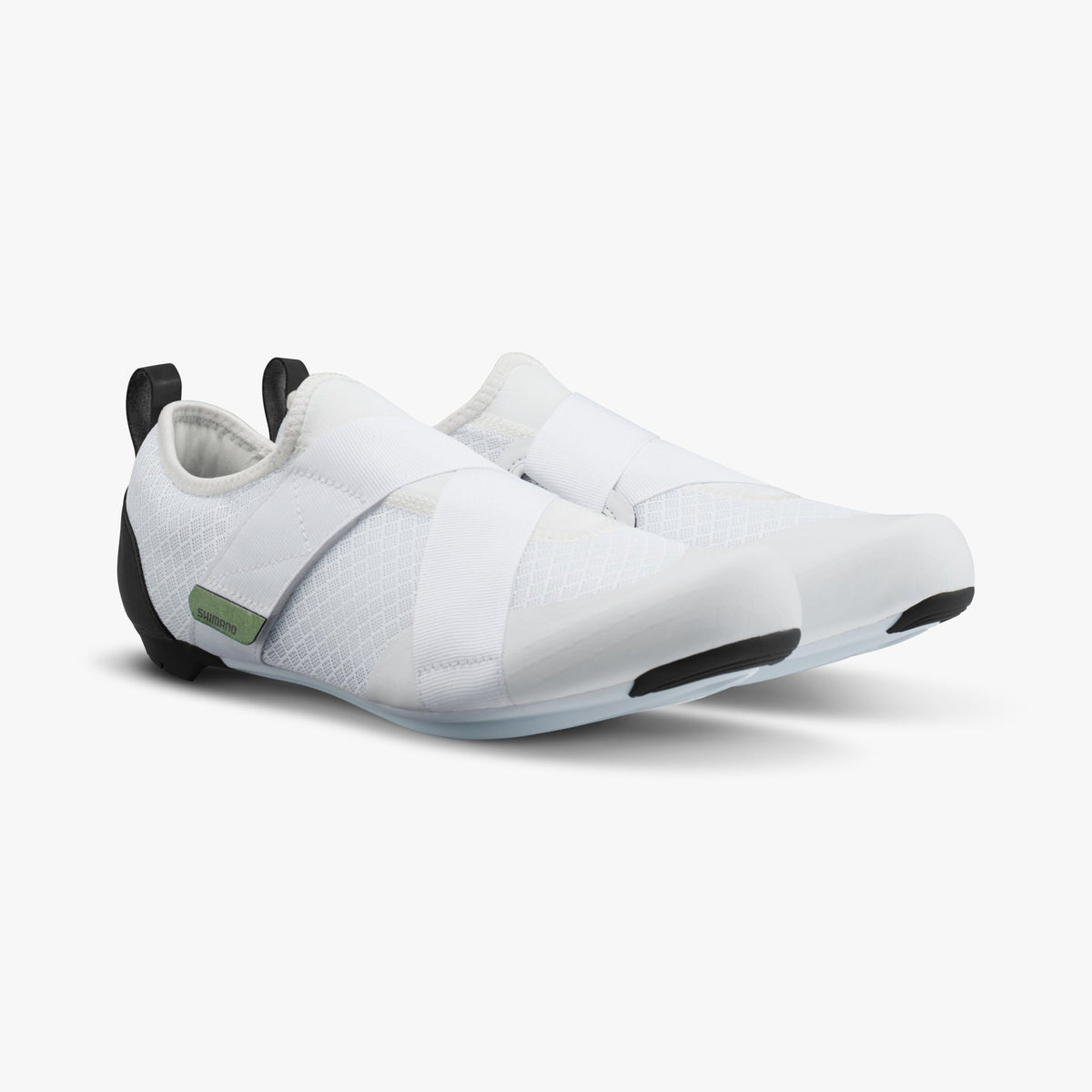White Shimano women's cycling shoes with crossed hook-and-loop straps and black heel tabs