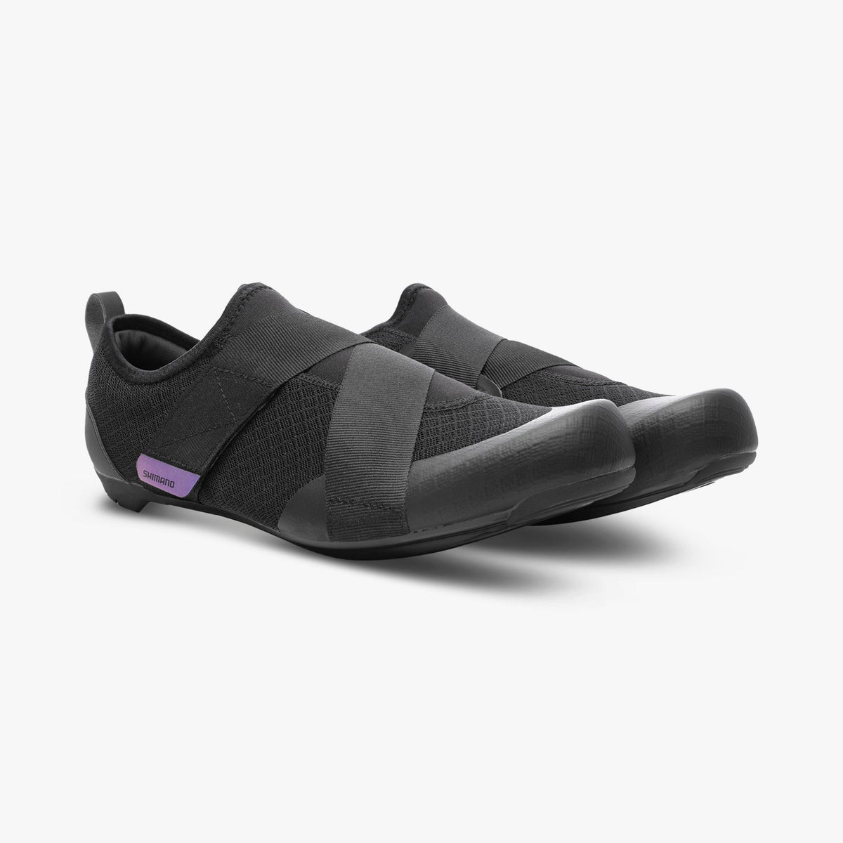Black Shimano women's cycling shoes with crossed hook-and-loop straps and purple side badges