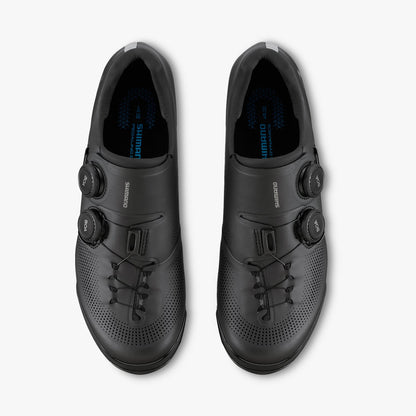 Pair of black cycling cleat shoes with perforated toe and lace-up front